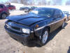 black dodge challenger with white stripes and alloy wheels